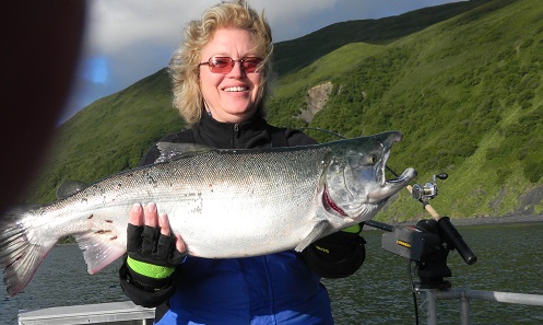 Travel Expert Lisa holding large silver salmon in arms