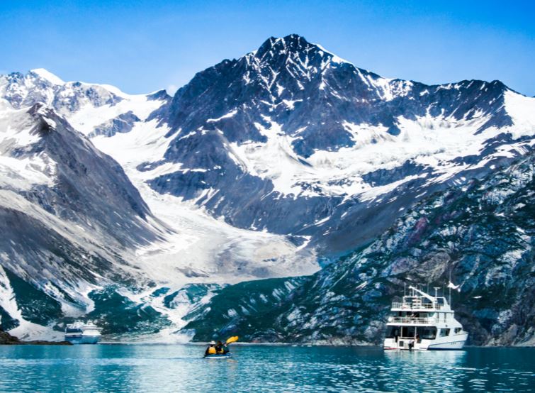 picture of boats in the water in front of mountains with glaciers at Glacier Bay Alaska