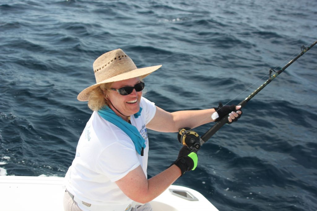 Lisa Travel Expert Fishing on Back of Boat