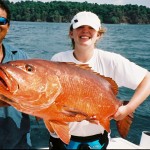 girl with Cubera Snapper on a boat in Costa Rica